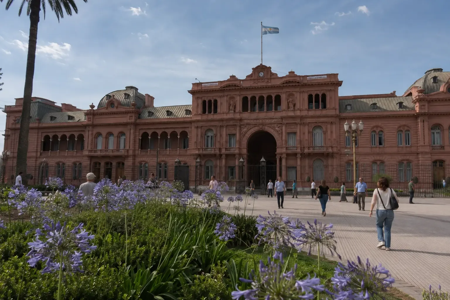 Casa Rosada seen from Plaza de Mayo with flowers and visitors in Buenos Aires